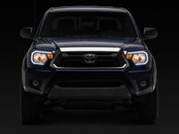 Raxiom 12-15 Toyota Tacoma Axial Series Headlights/Seq LED Bar- Black- Clear Lens