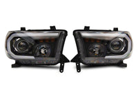 Raxiom 07-13 Toyota Tundra Axial Projector Headlights w/ SEQL LED Bar- Black Housing (Clear Lens)