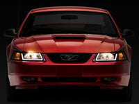 Raxiom 99-04 Ford Mustang Axial Series Headlights w/ LED Bar- Black Housing (Clear Lens)