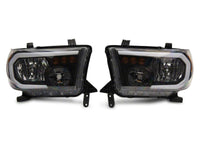 Raxiom 07-13 Toyota Tundra Axial Series Headlights w/ LED Bar- Black Housing (Clear Lens)