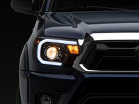 Raxiom 12-15 Toyota Tacoma Axial Projector Headlights w/ SEQL LED Bar- Black Housing (Clear Lens)